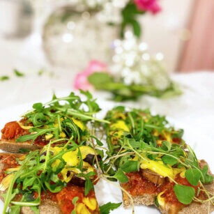 En vegansk och glutenfri pizza med hemmagjord tomatsås, toppad med ruccola.